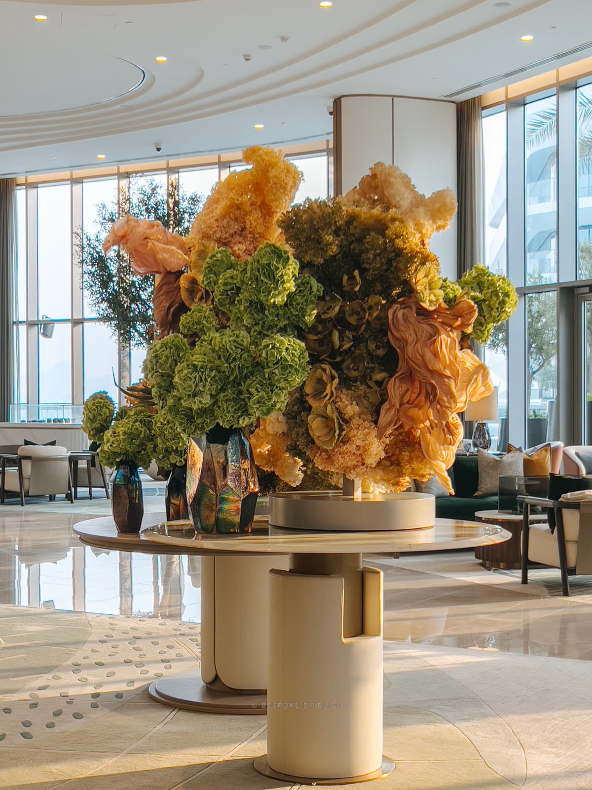 Statement floral arrangement in olive, peach and gold