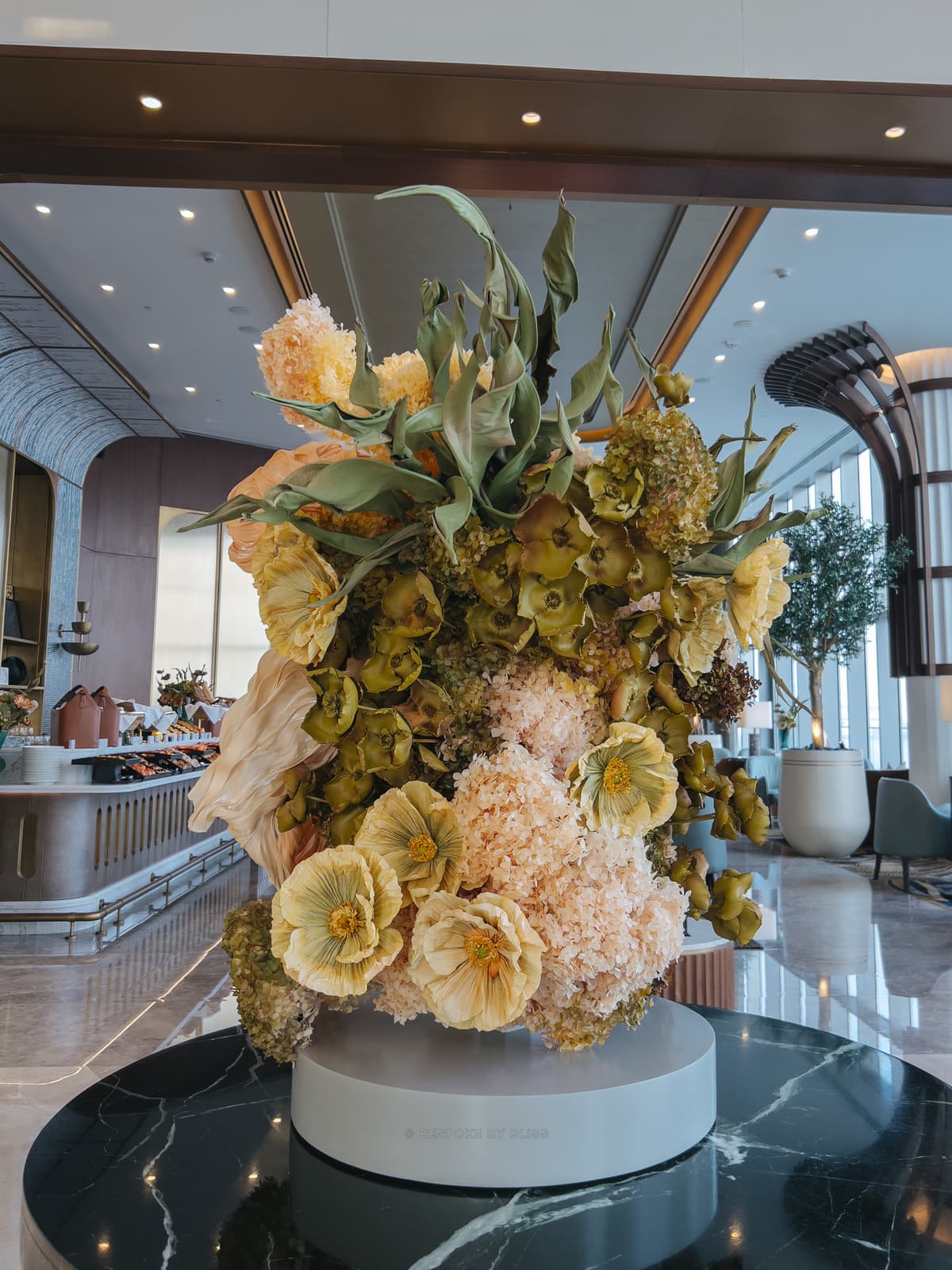 Statement floral arrangement in olive, peach and yellow
