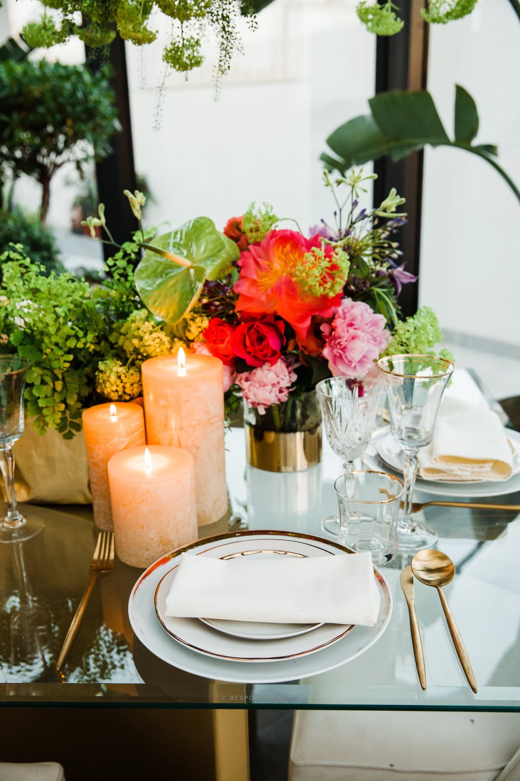 Table setting detail in coral, green and gold