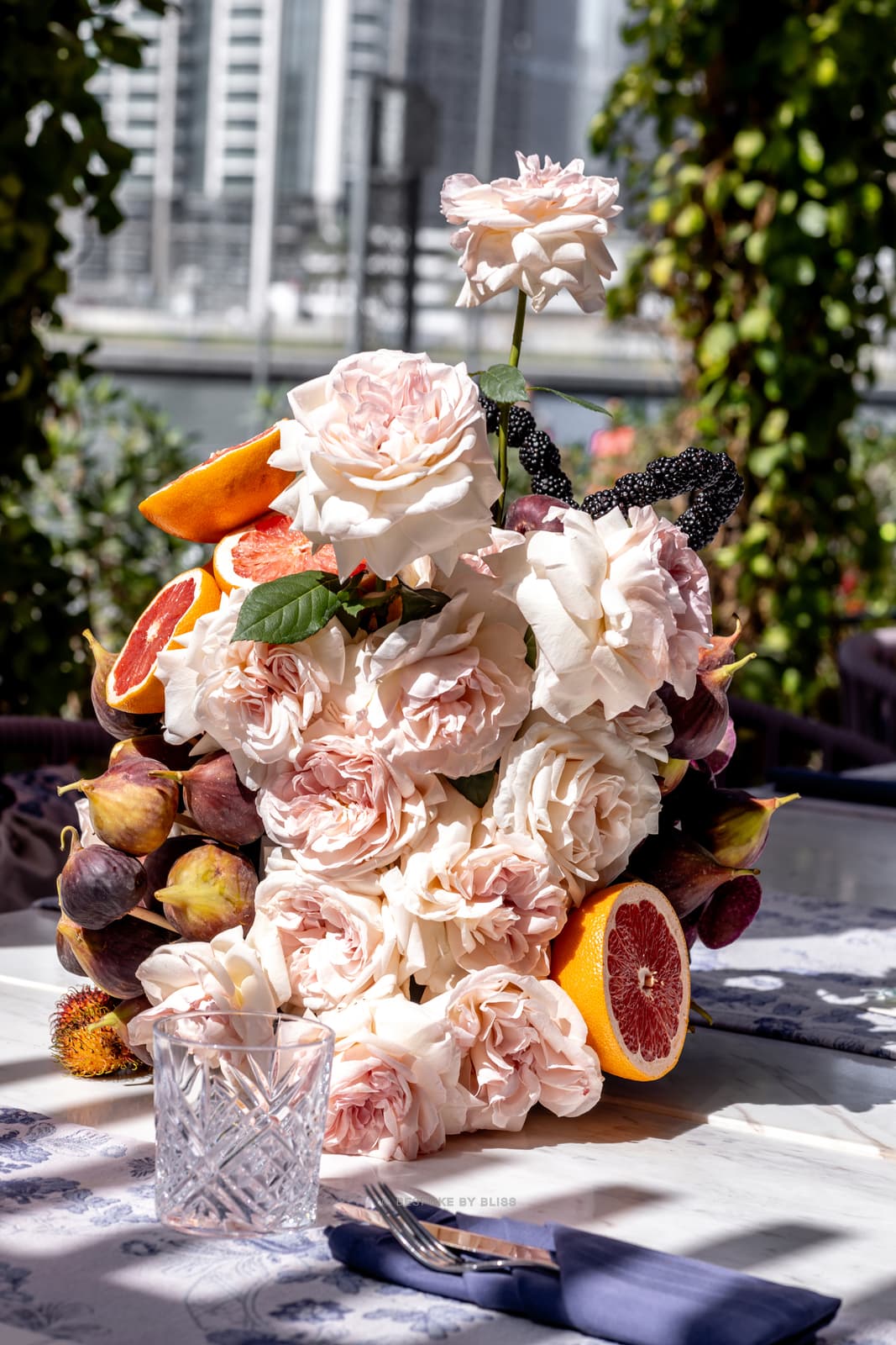 Table centrepiece in blush, orange and plum