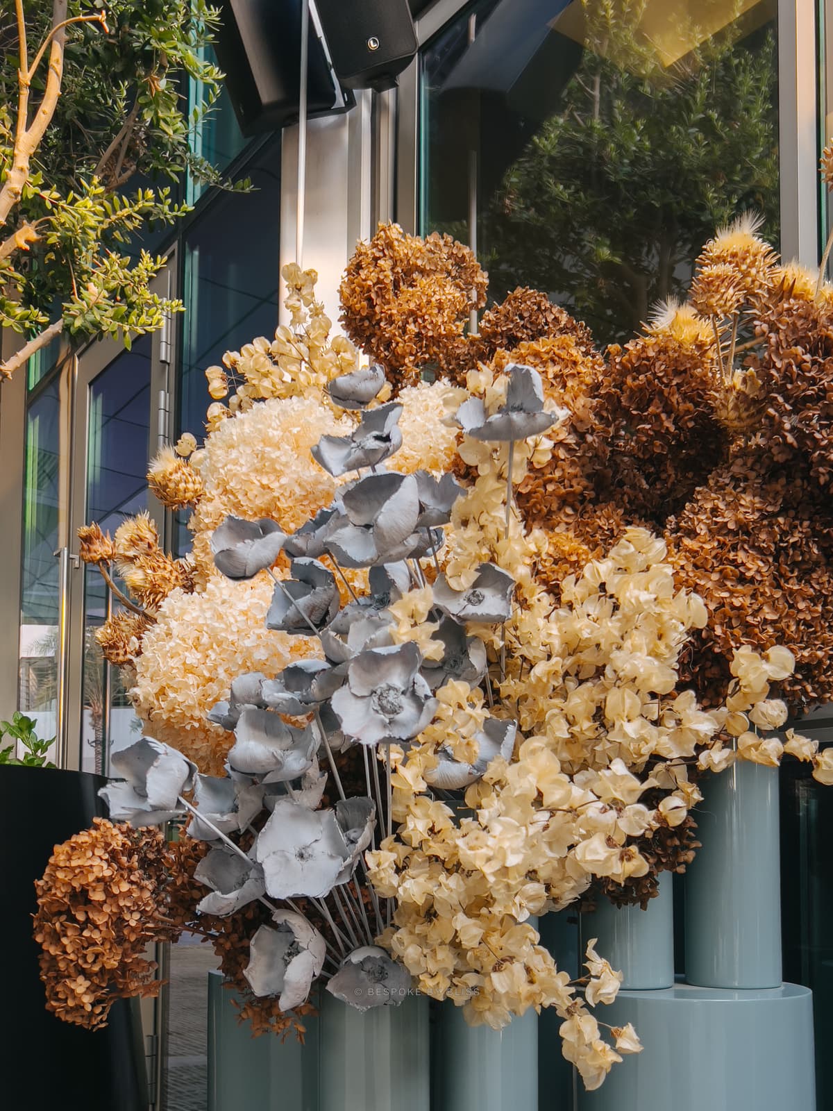 Statement floral arrangement in tan, cream and dusty blue