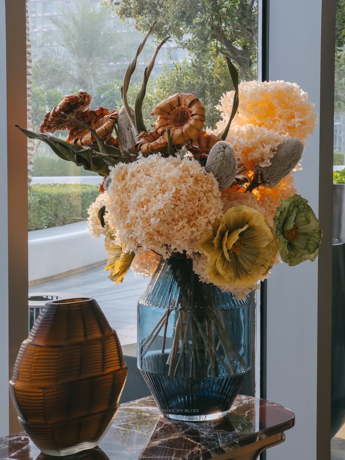 Statement floral arrangement in peach, copper and blue