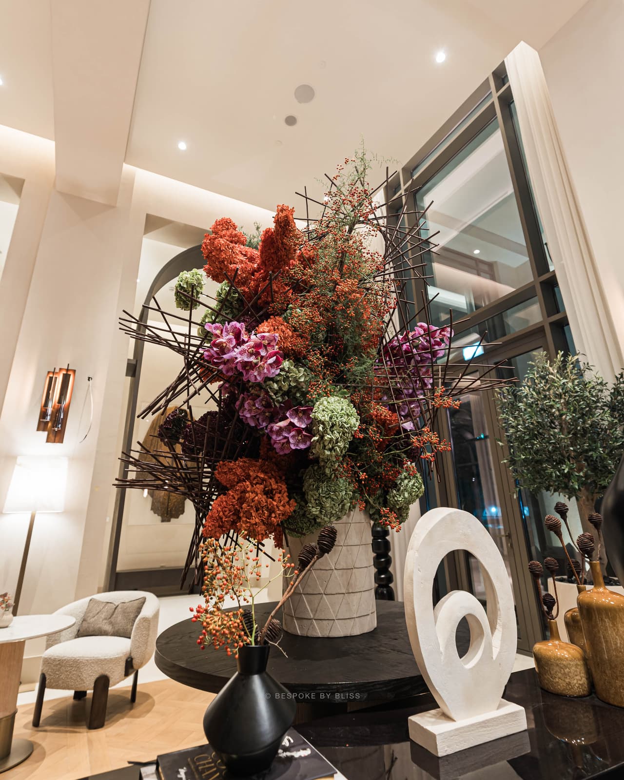 Statement floral arrangement in rust, magenta and green