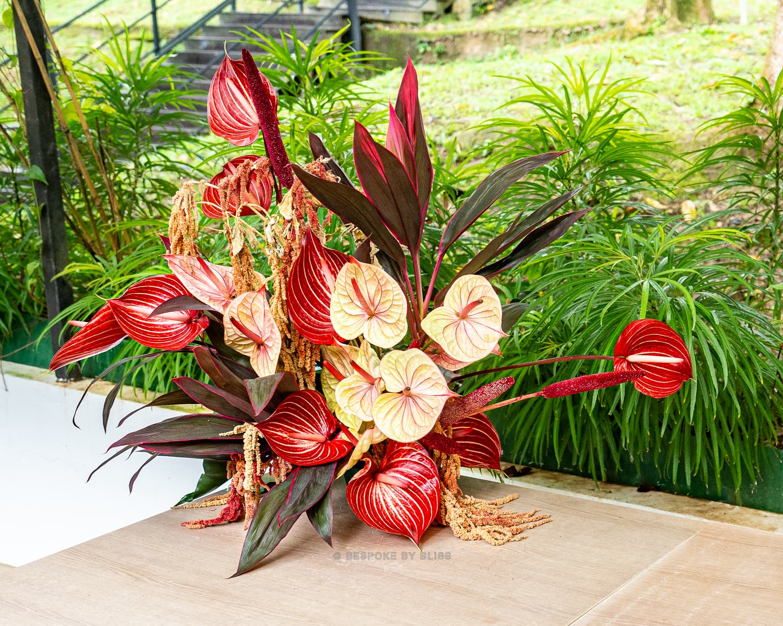 Statement floral arrangement in red, cream and burgundy
