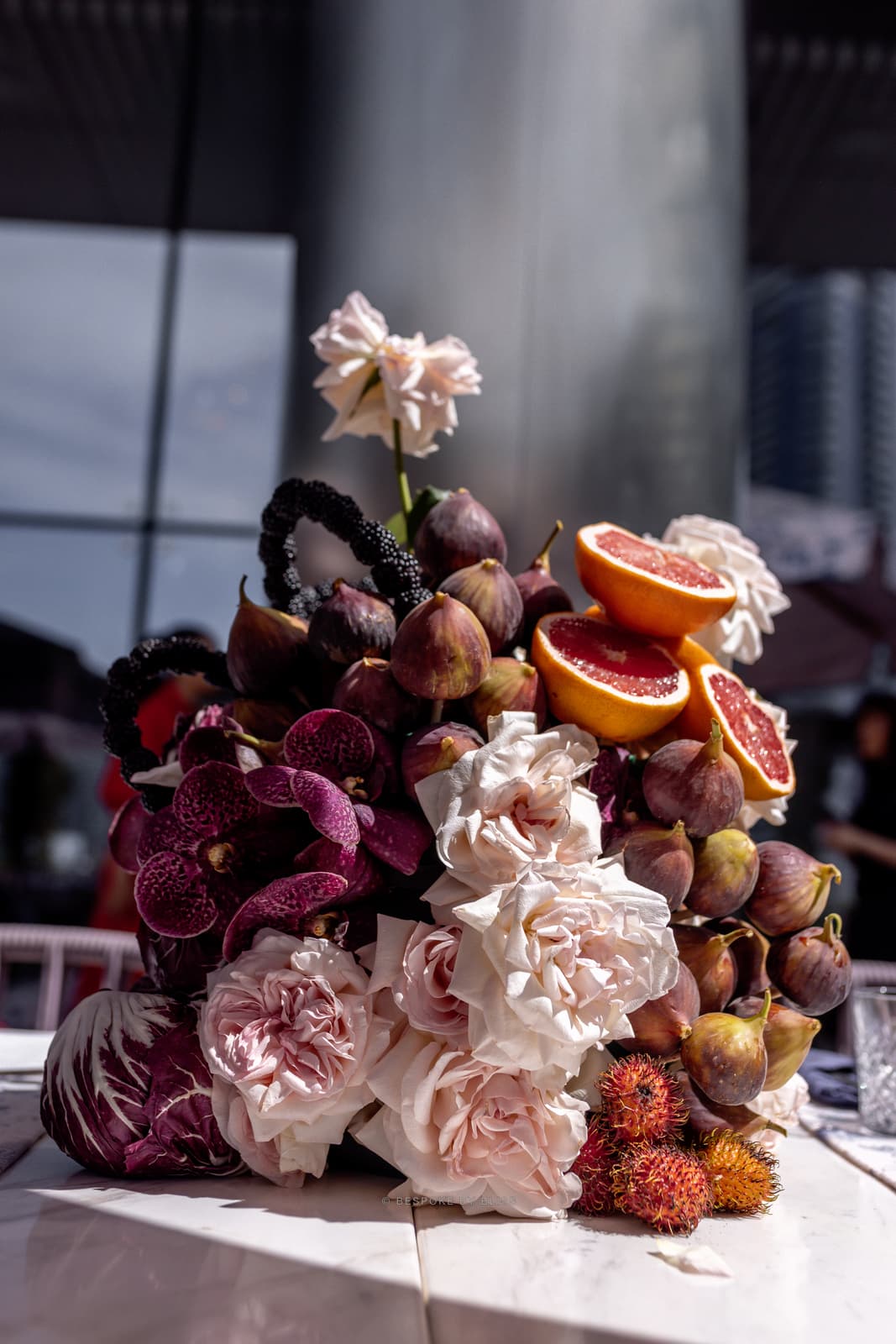 Table centrepiece in blush, plum and coral