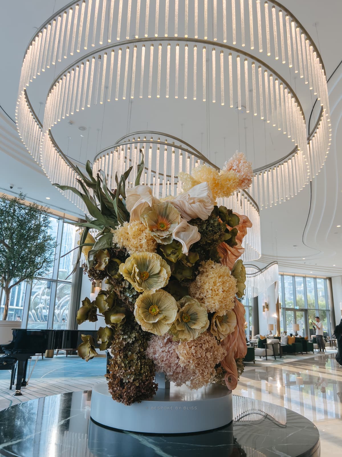 Statement floral arrangement in yellow, peach and olive